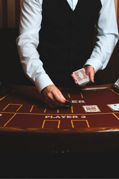 Ein Croupier verteilt Karten an einem Spieltisch im Casino-Stil mit Chips und Spielkarten beim Silvesterabend